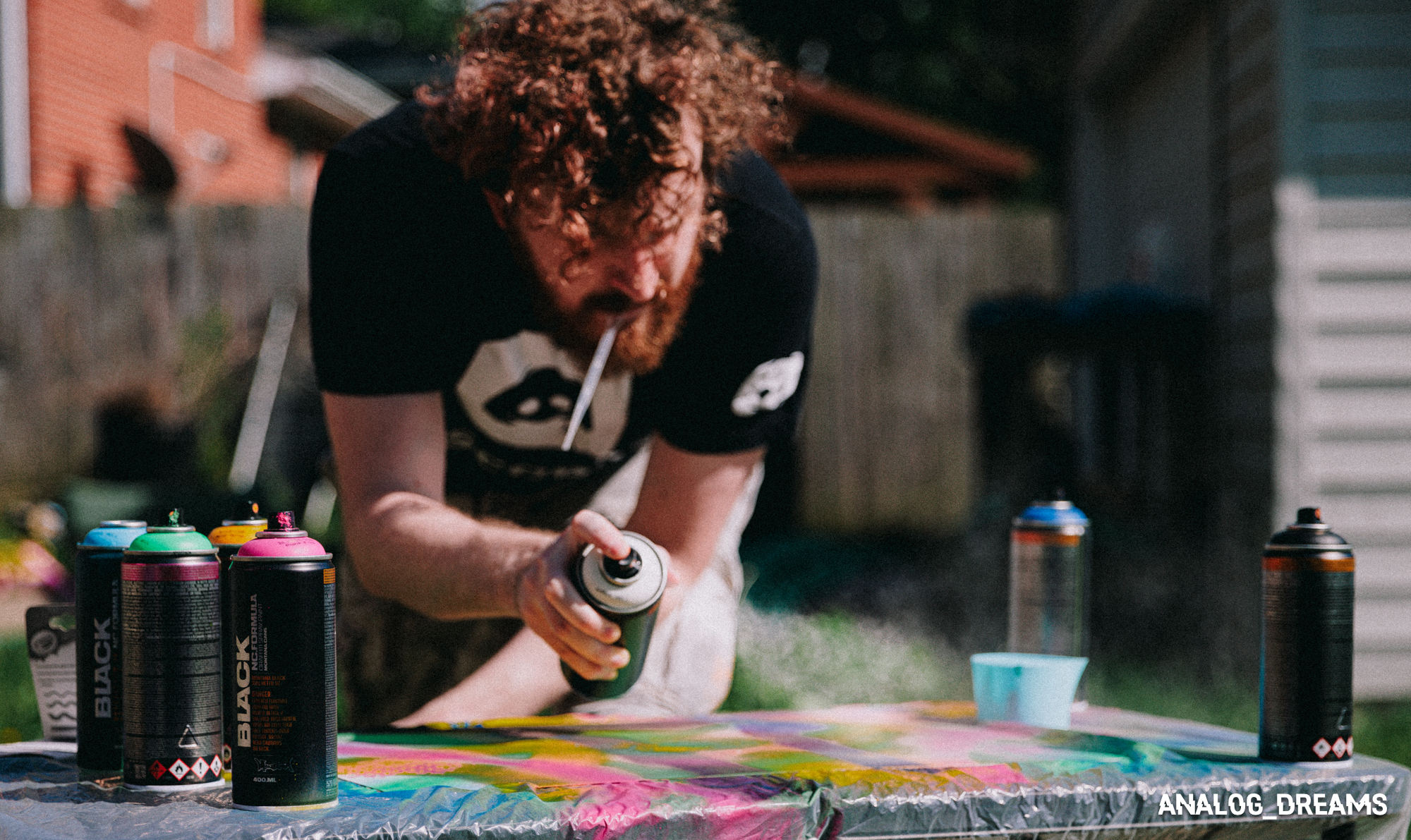 Photo of Addie spray painting a new project.