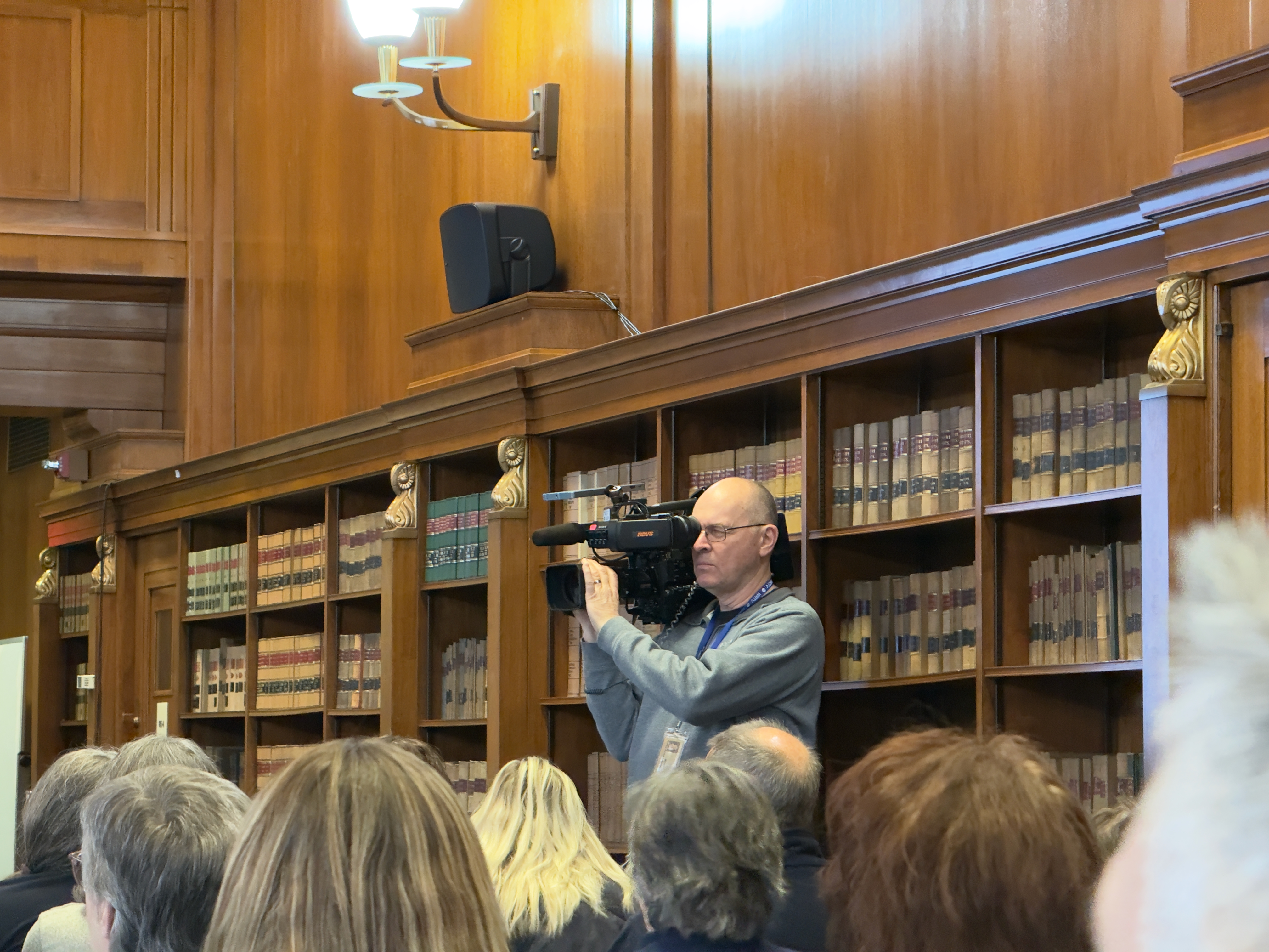 An ENG camera operator films the event.